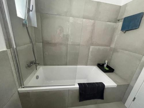 a bathroom with a bath tub with a shower at Shaunagh's Place in Kalymnos