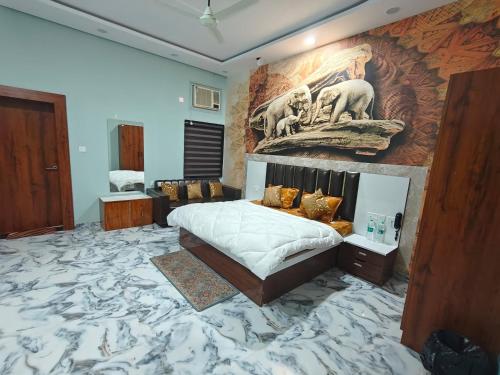 a bedroom with a large mural on the wall at The KP RESORT in Chīrgaon