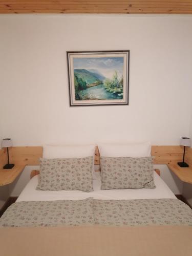 a bedroom with a bed with a picture on the wall at Baranja Black Hill's in Gajić
