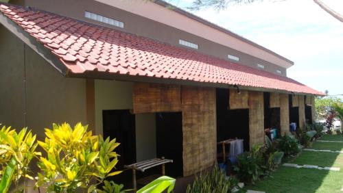 a building with a red roof at Relaxing Homestay in Kuta Lombok