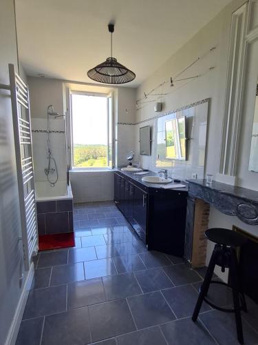 a large bathroom with a sink and a shower at La Gironie in Pomport