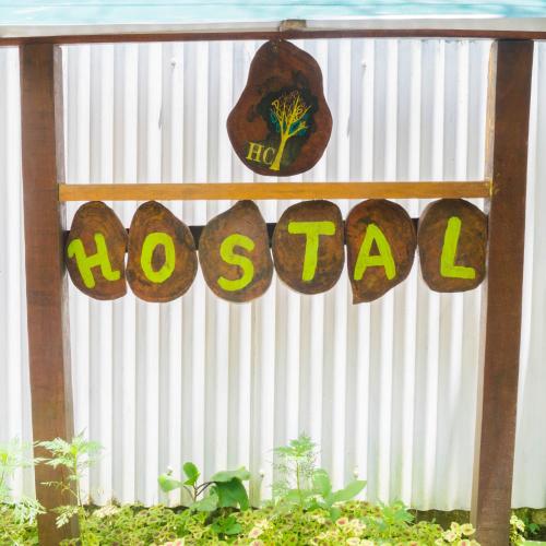a sign that says hosanna on a white fence at Hostal Cecilia in Puerto Viejo