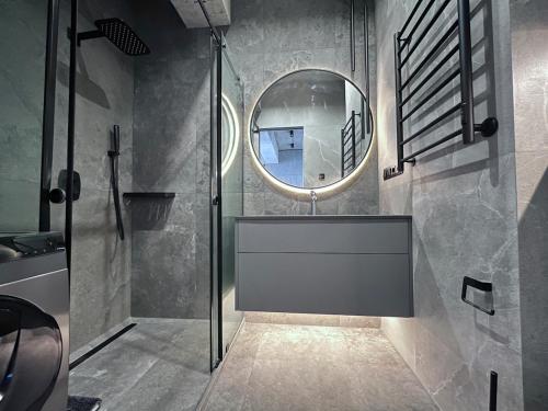 a bathroom with a sink and a mirror at Designer View Vake in Itʼkhvisi