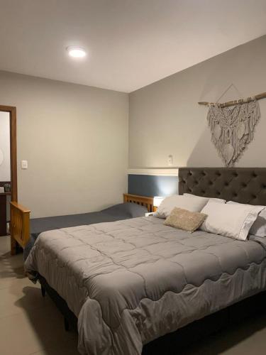 a bedroom with a large bed in a room at Hotel Zona Sul in São Gabriel