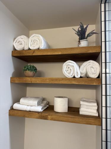 a bathroom with wooden shelves with towels at Base Camp for all of Sandpoint and Lake Pend Oreille Adventures in Sandpoint