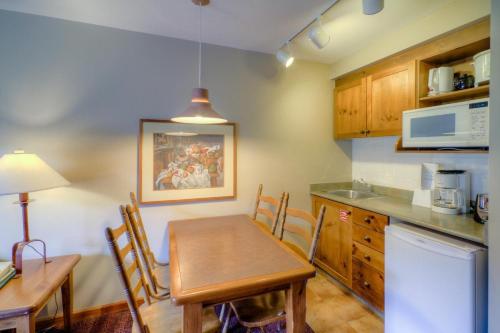 a kitchen with a table and a dining room at Cahilty #122 home in Sun Peaks