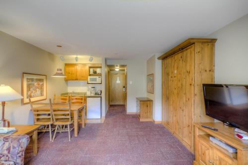 a living room with a kitchen and a dining room at Cahilty #122 home in Sun Peaks
