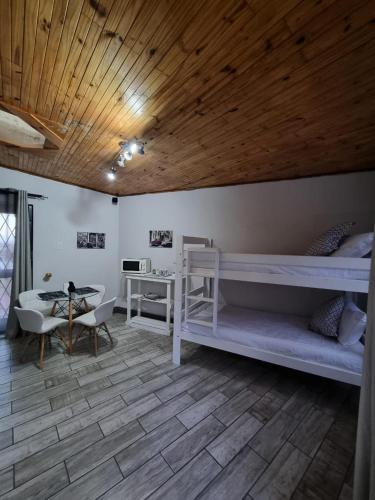 a bedroom with two bunk beds and a desk at Seaview Serenity in Gqeberha