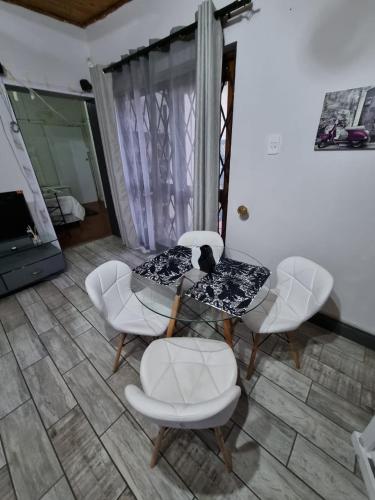 a room with chairs and a table with an umbrella at Seaview Serenity in Gqeberha