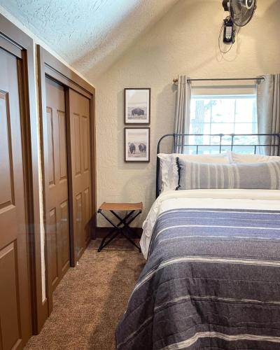 a bedroom with a bed and a window at The Little Dipper Cabin in Shaver Lake