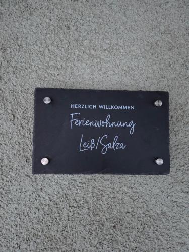 a sign on a wall with writing on it at Ferienwohnung Salza in Nordhausen