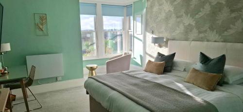 a bedroom with a large bed and a window at Hotel Penzance Harbour View in Penzance