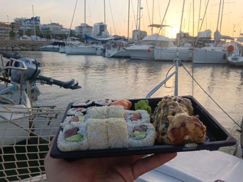 a person holding a tray of food on a boat at Jack Sparrow in Puerto de Gandía