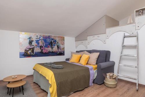 a bedroom with a bed and a loft bed with a ladder at Adria in Vodice