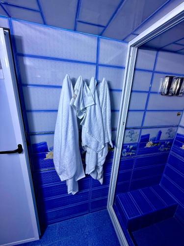 a bathroom with white towels hanging on a rack at Fes Apartment 2 in Fez