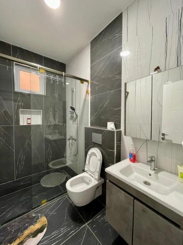 a bathroom with a toilet and a sink at Aqua Azuri apartment in Mombasa