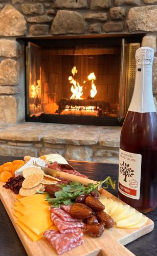 a plate of food and a bottle of beer next to a fireplace at Waterbury Inn in Ephraim