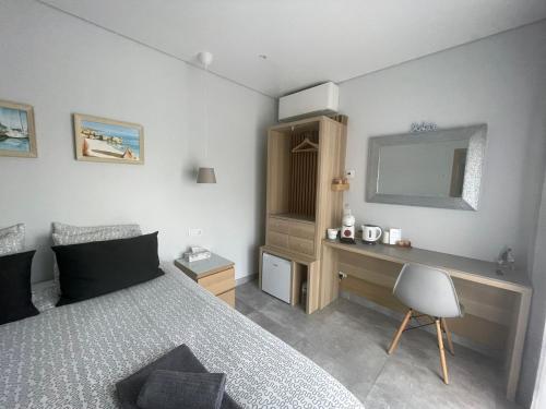 a bedroom with a bed and a desk and a mirror at SalemaView Ensuite bedroom in Salema