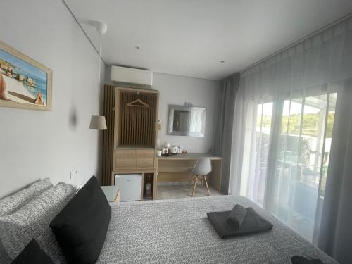 a bedroom with a bed and a desk and a window at SalemaView Ensuite bedroom in Salema