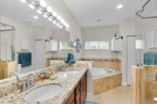 a bathroom with two sinks and a tub at Casa Mar in Islamorada