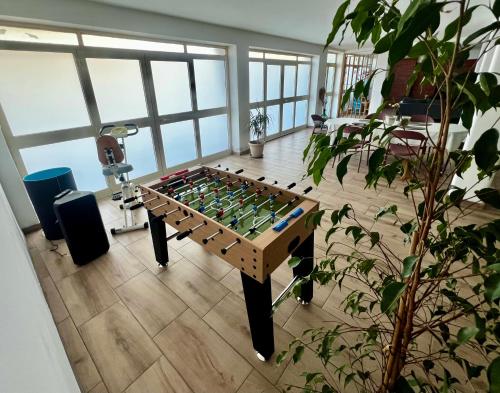 a room with a foosball table in a room at Domus Apartment in villa, swimming pool and private parking in Gravina di Catania