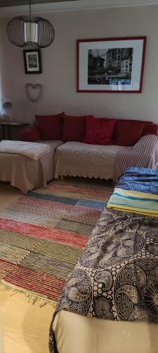 a living room with two beds and a couch at Kerrostalomajoitus in Riihimäki