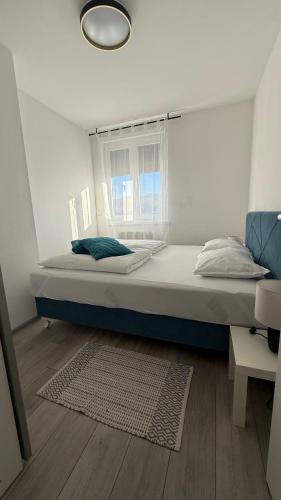 a large bed in a room with a window at Apartman Vrućica view in Teslić