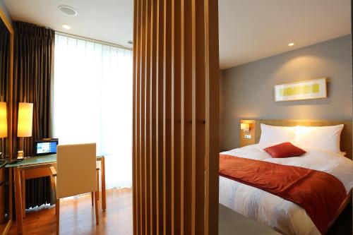 Ένα ή περισσότερα κρεβάτια σε δωμάτιο στο HOTEL MYSTAYS Oita