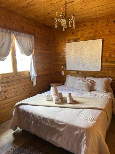 a bedroom with a large bed with towels on it at Mini Inca Roca in Uspallata