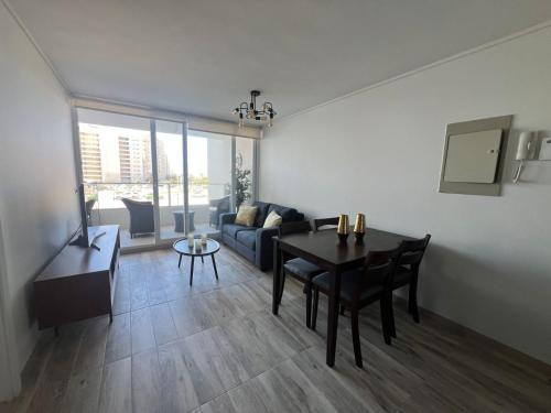 a living room with a table and a couch at Laguna del Mar, Playa Arrecife in La Serena