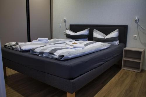a bed with two towels on top of it at Ferienhaus Noa in Twist