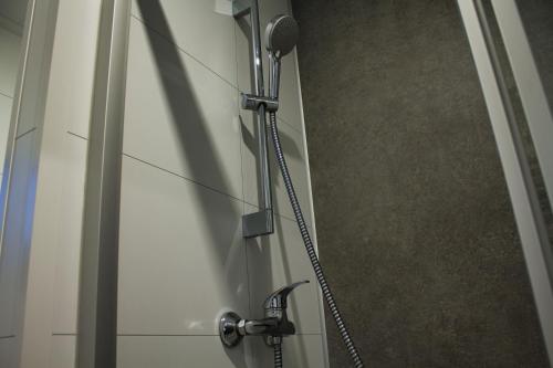a shower with a hose attached to a door at Ferienhaus Noa in Twist
