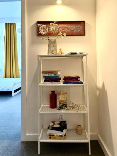 a book shelf in a room with books at Expo Śniadeckich in Poznań