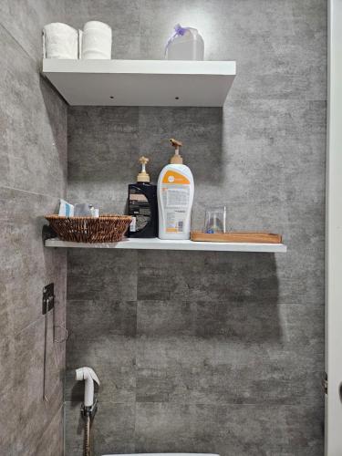 a bathroom with a shelf with a bottle of soap at LoCo Fully Equipped House - 2BR3WS in Ho Chi Minh City
