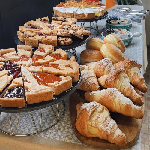 a display of different types of bread and pastries at Casale la Decima in Budrio