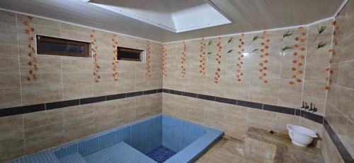 a bathroom with a tub with a toilet in it at Onur Termal in İhsaniye