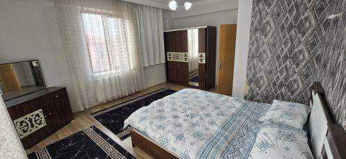 a bedroom with a bed and a television in it at Onur Termal in İhsaniye
