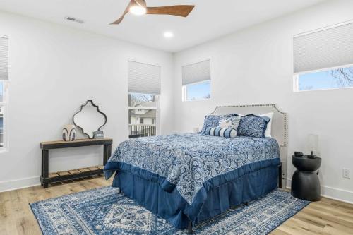 a bedroom with a bed and a ceiling fan at Near Indy Attractions • Deck • Patio • Fenced Yard in Indianapolis