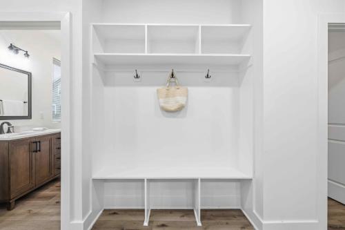 a bathroom with white walls and a sink and a counter at Near Indy Attractions • Deck • Patio • Fenced Yard in Indianapolis