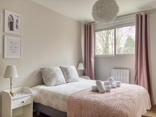 a bedroom with a bed with two teddy bears on it at Parisian escape near Disney - Liz Appart in Montévrain