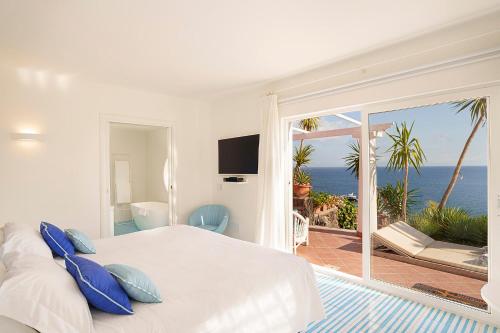 a bedroom with a bed and a view of the ocean at Hotel Continental Mare in Ischia Town
