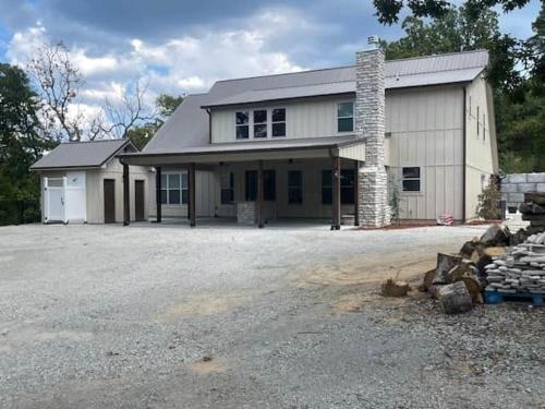 a large white house with a large driveway at Lakeside Oasis in Longtown