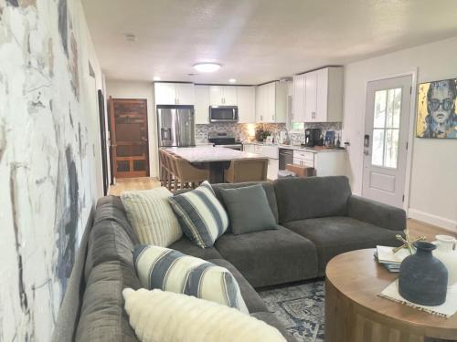 a living room with a couch and a kitchen at Brush Hill Lakehouse in Checotah