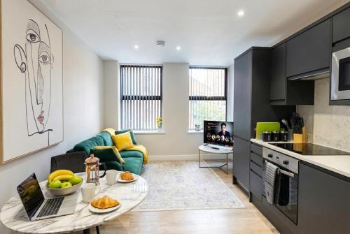 a kitchen and living room with a table and a couch at City Spacious Apartment in Central Station