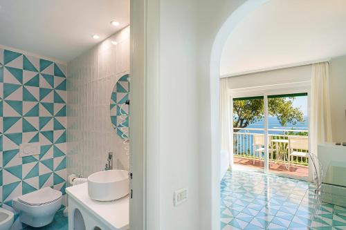 a bathroom with a toilet and a sink at Hotel Continental Mare in Ischia Town