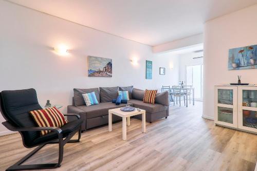 a living room with a couch and a table at Apartment Centeanes in Carvoeiro