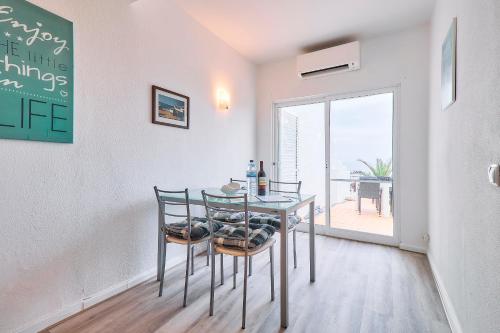 a dining room with a table and chairs and a window at Apartment Centeanes in Carvoeiro