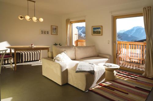a living room with a couch and a table at Haus Gerti in Ramsau am Dachstein