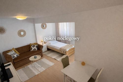 a living room with a bed and a couch at Pokój noclegowy in Józefowo