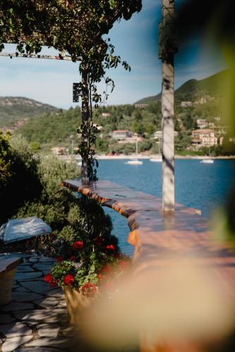 a walkway next to a body of water with flowers at Yioka House in Mikros Gialos
